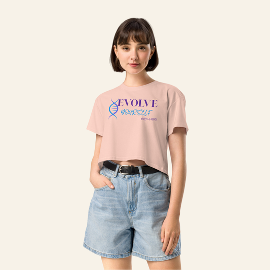 Person wearing a pink t-shirt with text and graphics, standing against a plain background